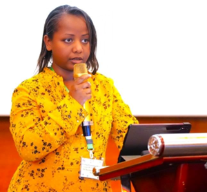 woman looking into microphone