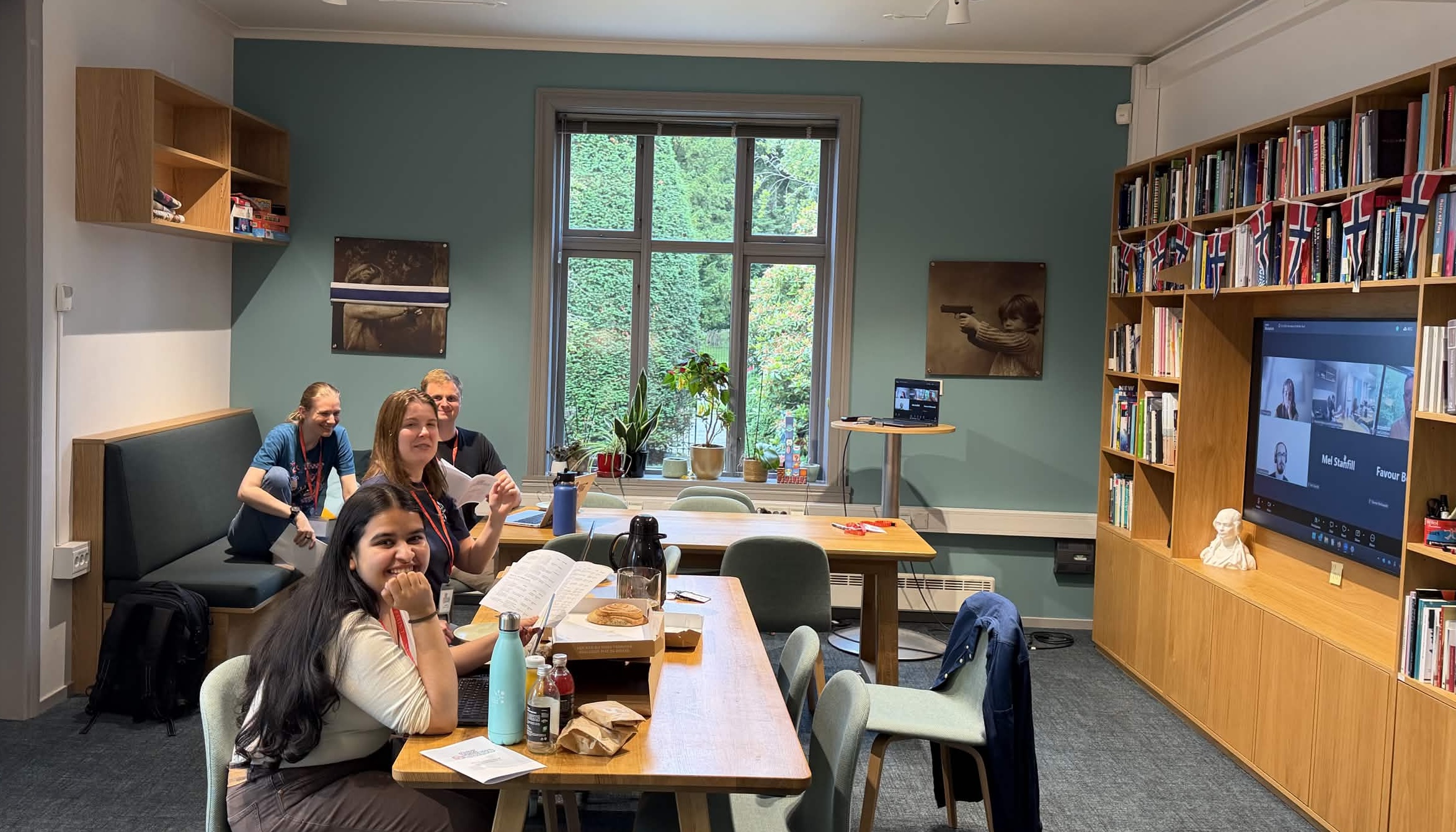 Four people gathered in the CDN offices