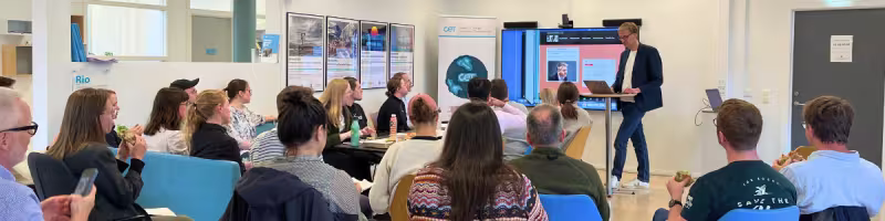 A group of people watching a presentation