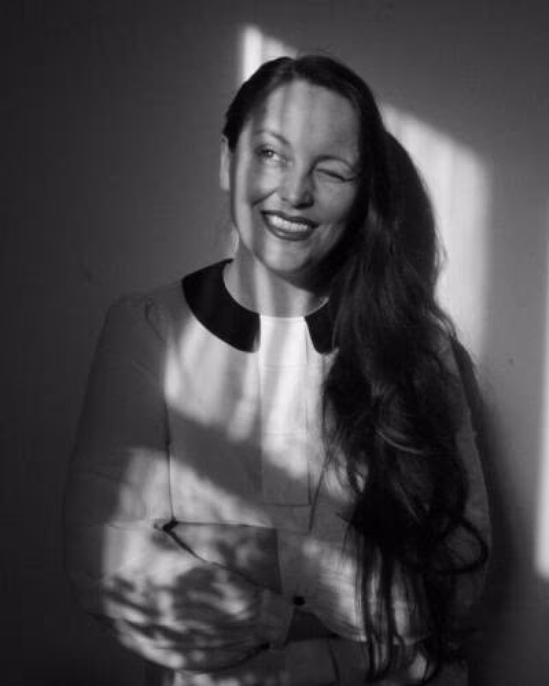 Black and white photo with young woman with sun in her eyes