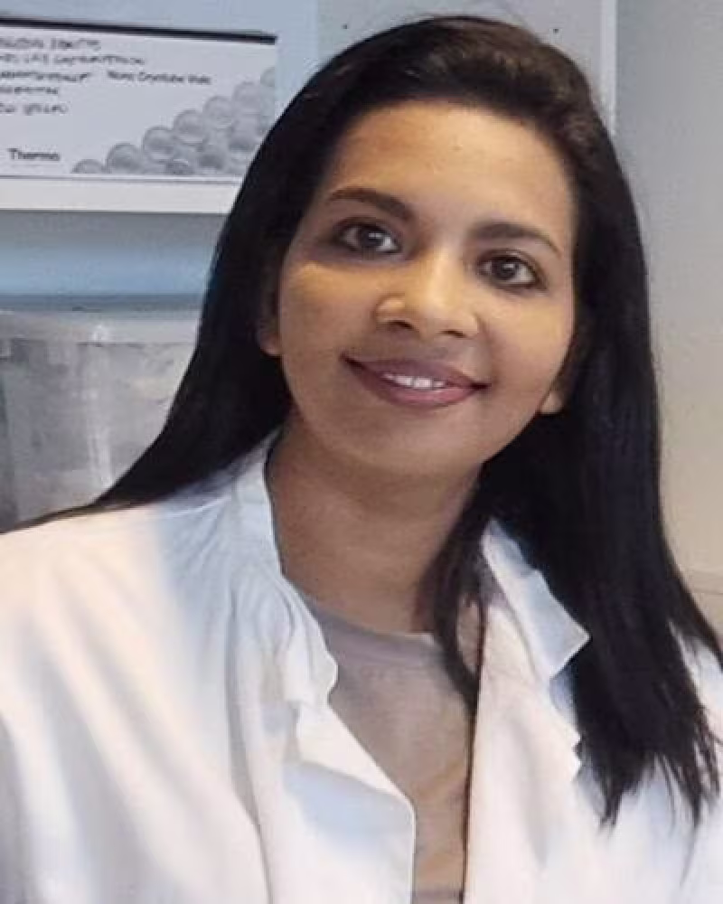 Woman with dark hair smiling at camera