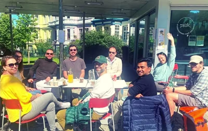 A GROUP HAVING LUNCH IN THE SUNSHINE