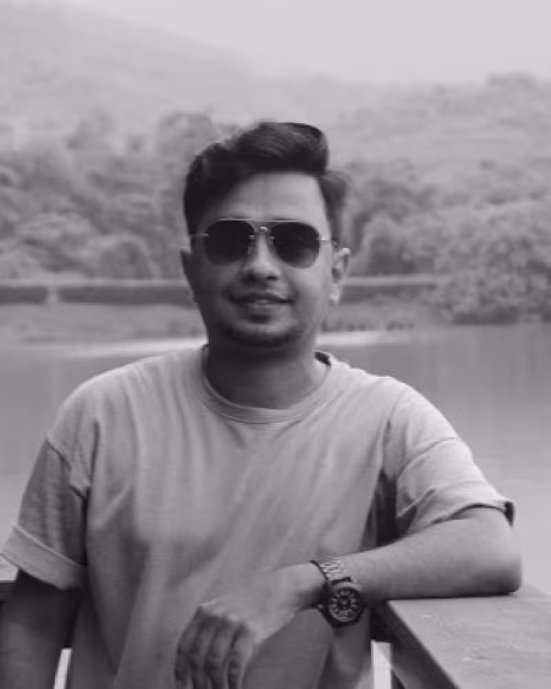 Young man in sunglasses smiling at camera