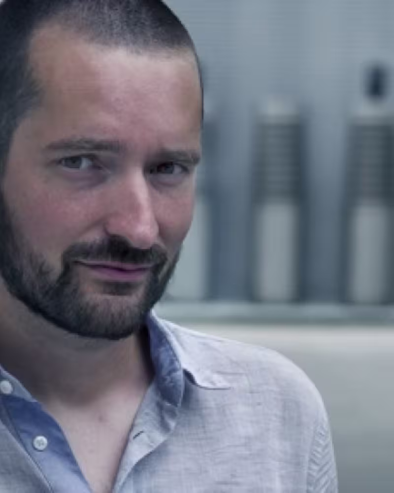 Man with short beard looking at camera