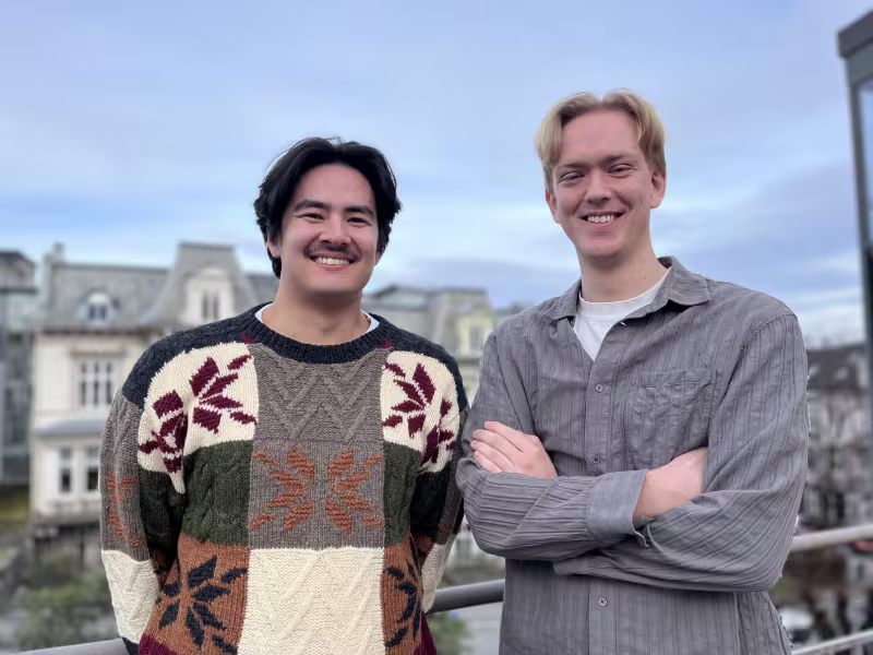 Two men smiling at the camera