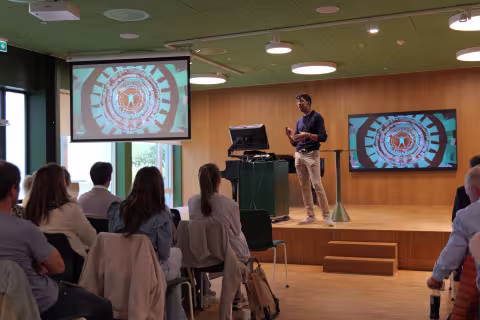 BCEPS Postdoctoral Research Fellow Anand Bhopal presenting on stage