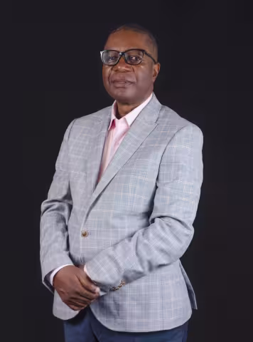 Profile picture, man wearing a grey suit jacket and white shirt.