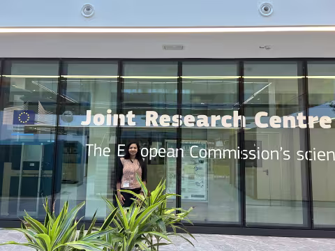 Young woman infront of glass building