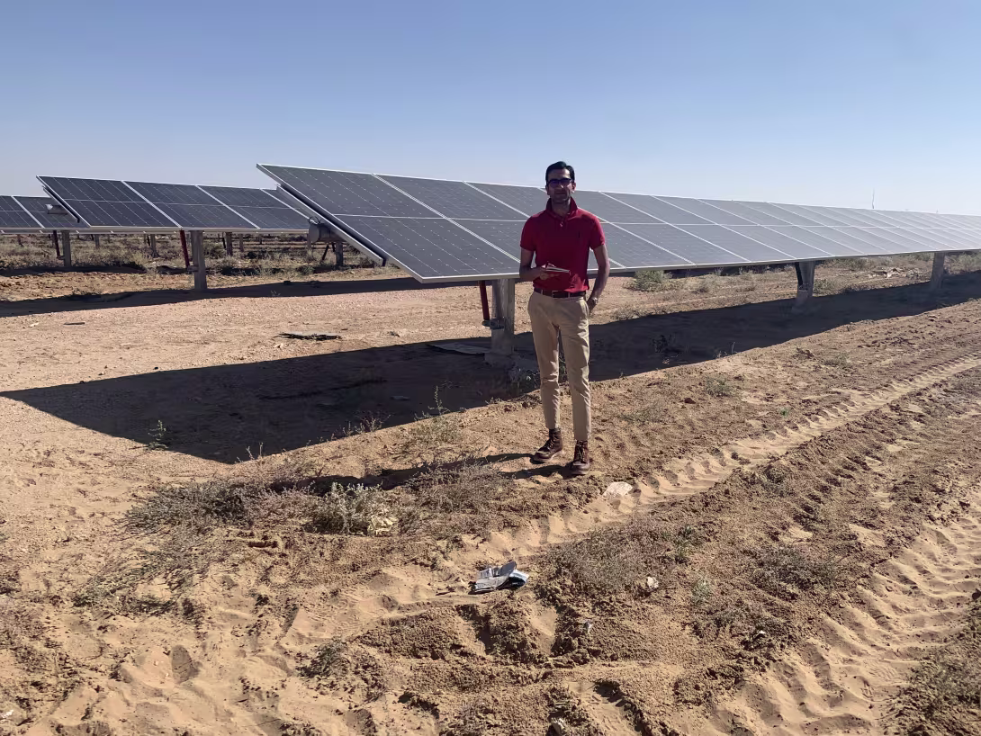 Image of Shayan in front of solar panels