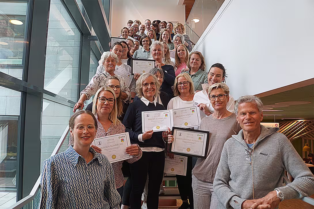 A large group of people standing in a stairs, posing for the camera.
