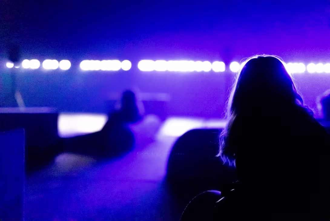 person from behind in a room with purple lightening