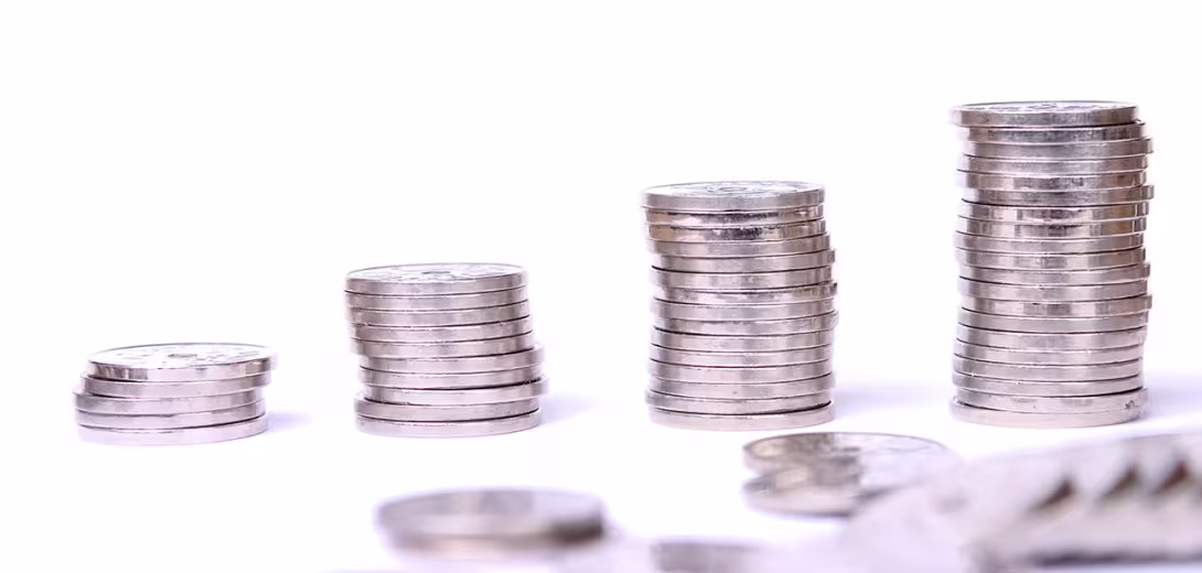 En voksende høyde av mynter i fire rader