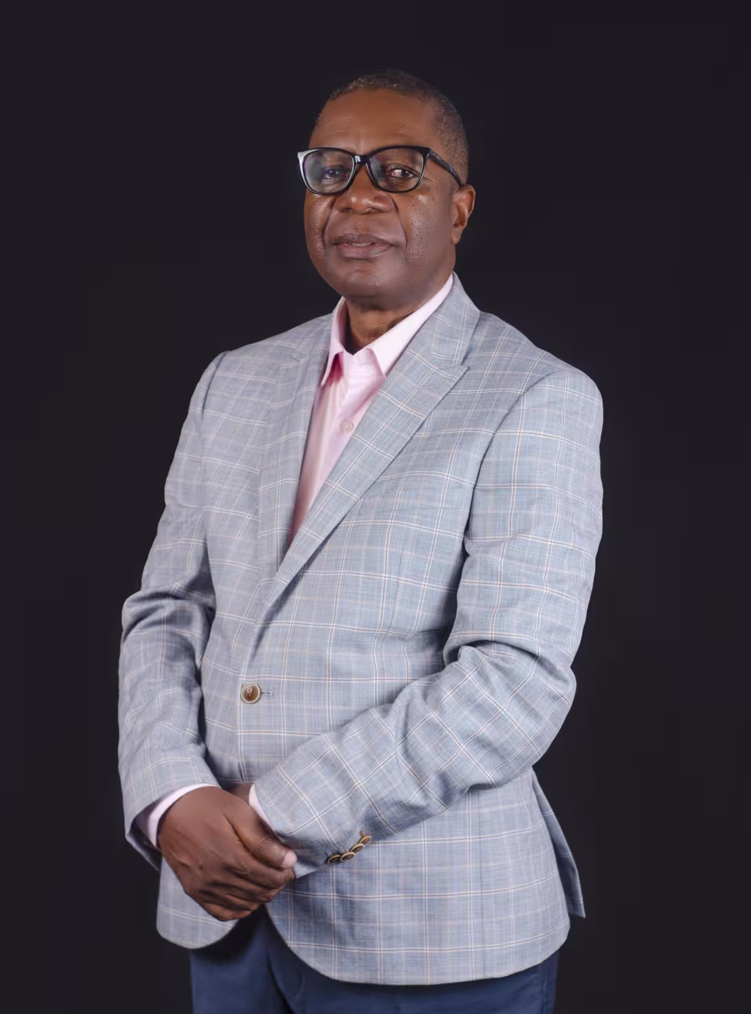 Profile picture, man wearing a grey suit jacket and pink shirt.