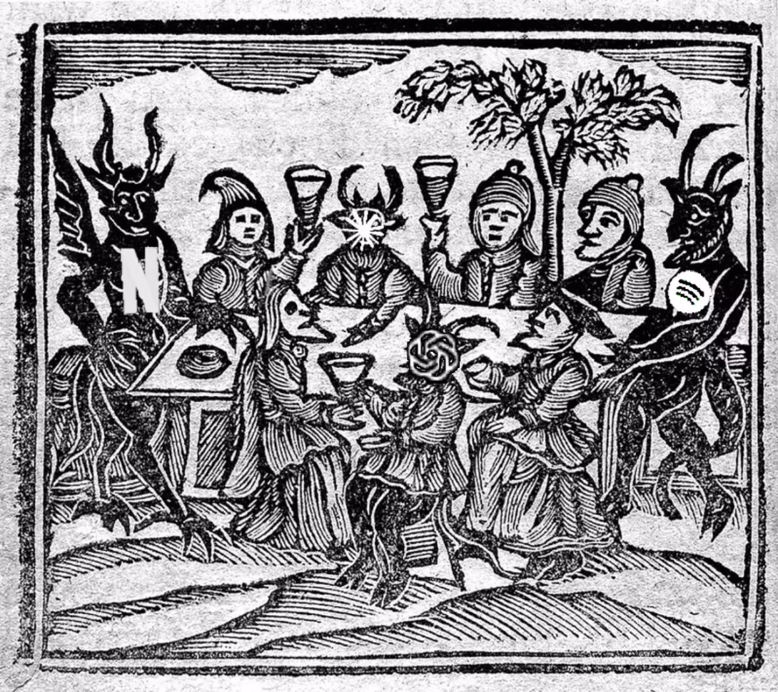 Demons and humans around a table. Old wood cutting.