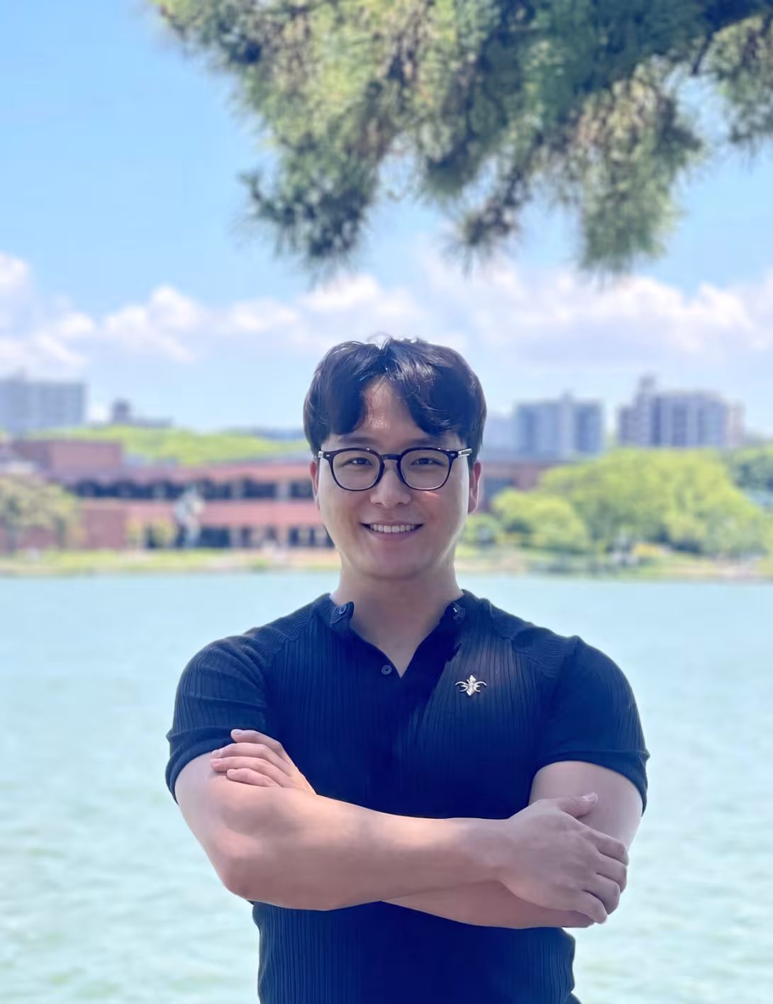 Young man with glasses smiling at camera