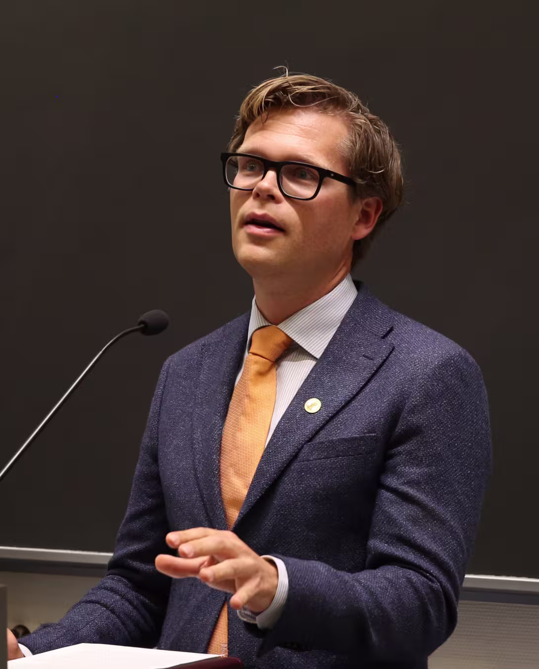 Bilete av Halvard Haukeland Fredriksen som taler til ei forsamling.